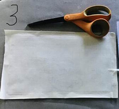 Images showing mask, ready for cutting holes for elastic bands